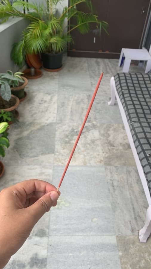 A hand holding one of Cense's first prototype incense sticks